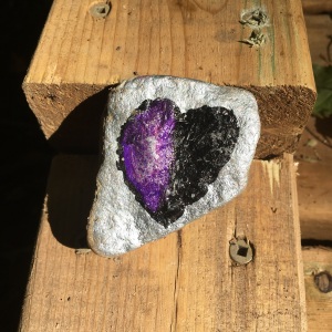 Rock painted with a purple hear